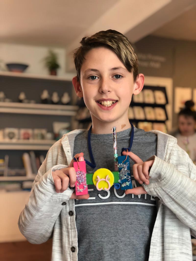 Young student showing jewellery piece